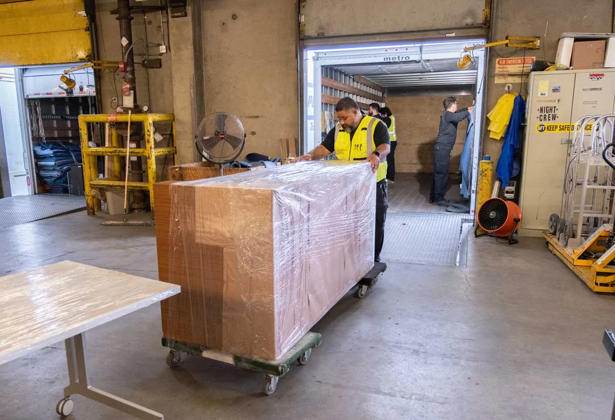 workers moving furniture during office decommissioning